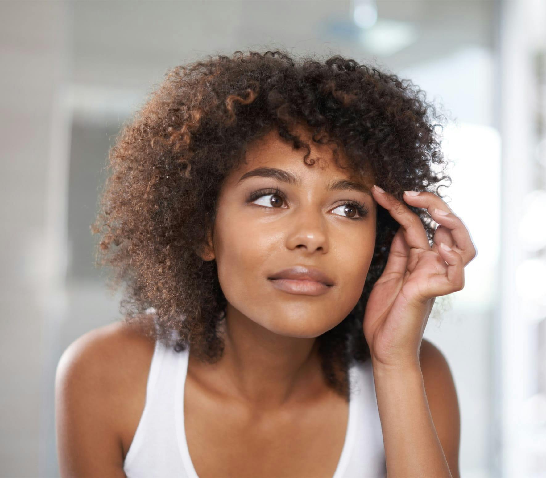 Woman brushing eyebrow
