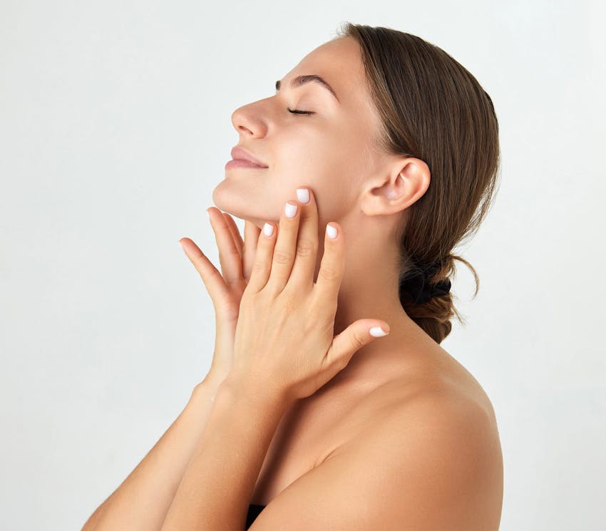 Woman feeling her cheeks