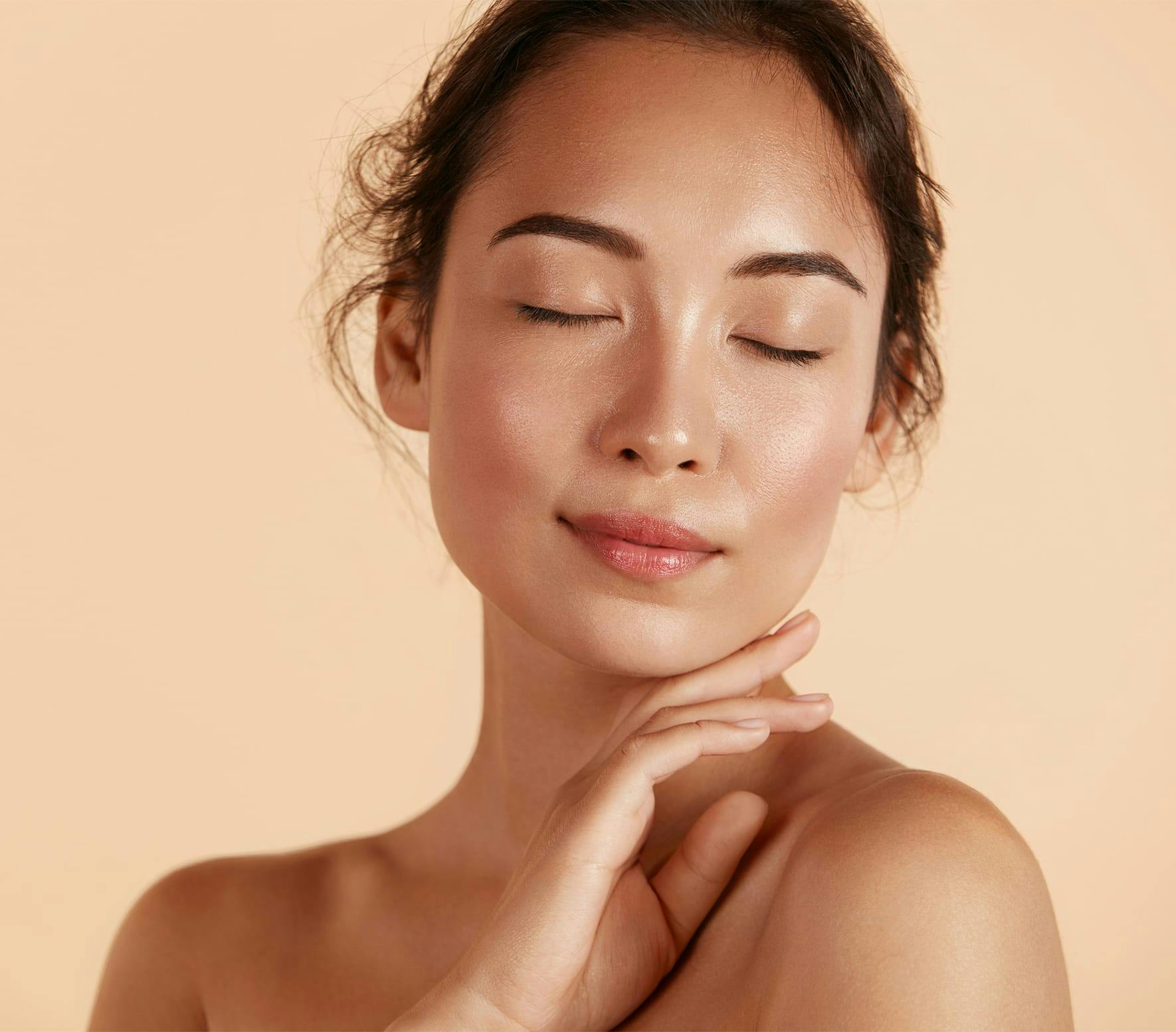 Woman touching chin with eyes closed