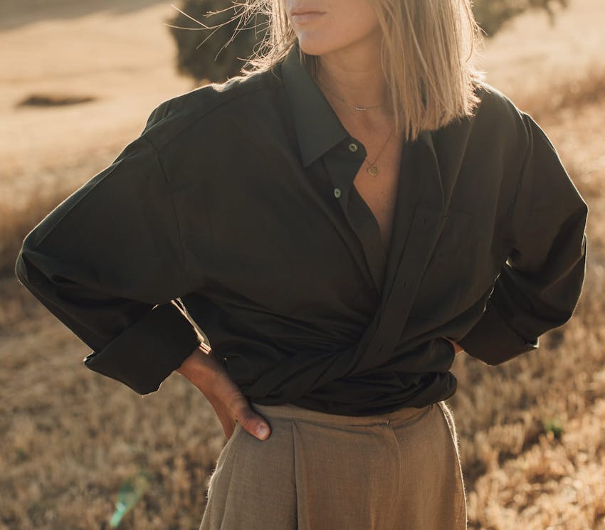 woman in a black top standing in a field