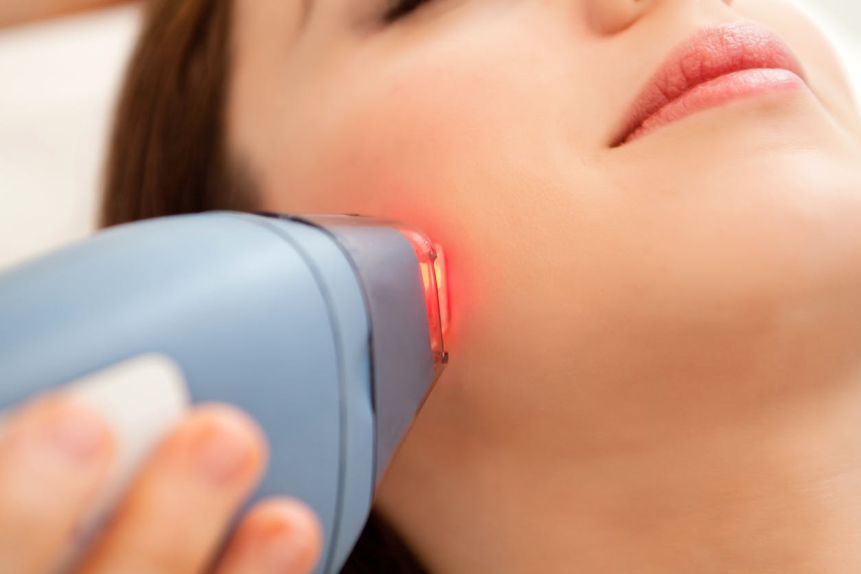 laser machine touching womans cheek