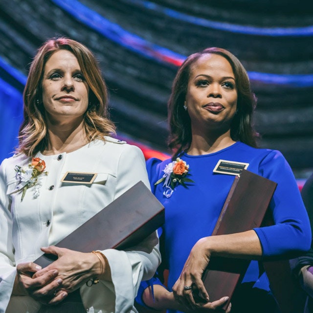 dr. sharitta gross standing with award
