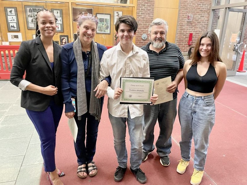 dr. sharitta gross standing with scholar and their family