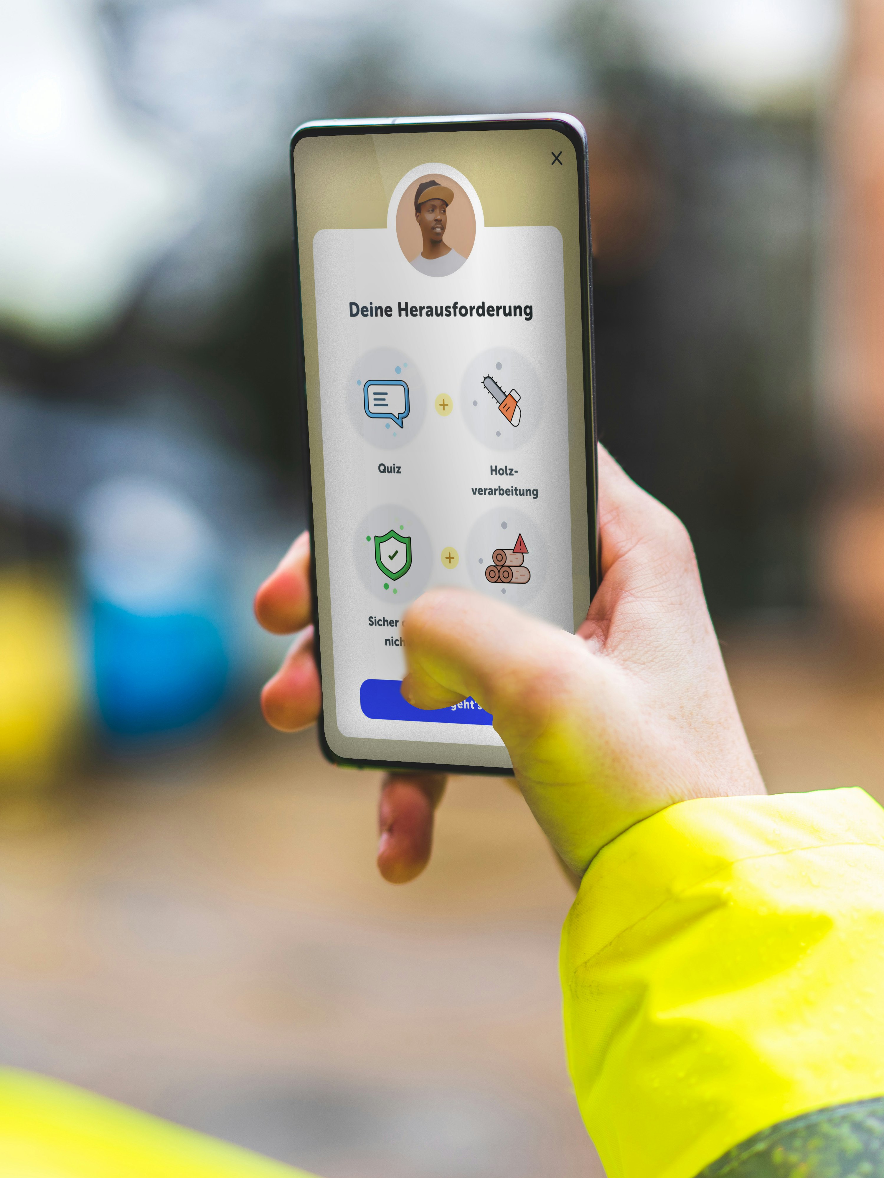 Person in a yellow jacket using a smartphone app with icons for quiz, media, and safety features, in an outdoor setting.