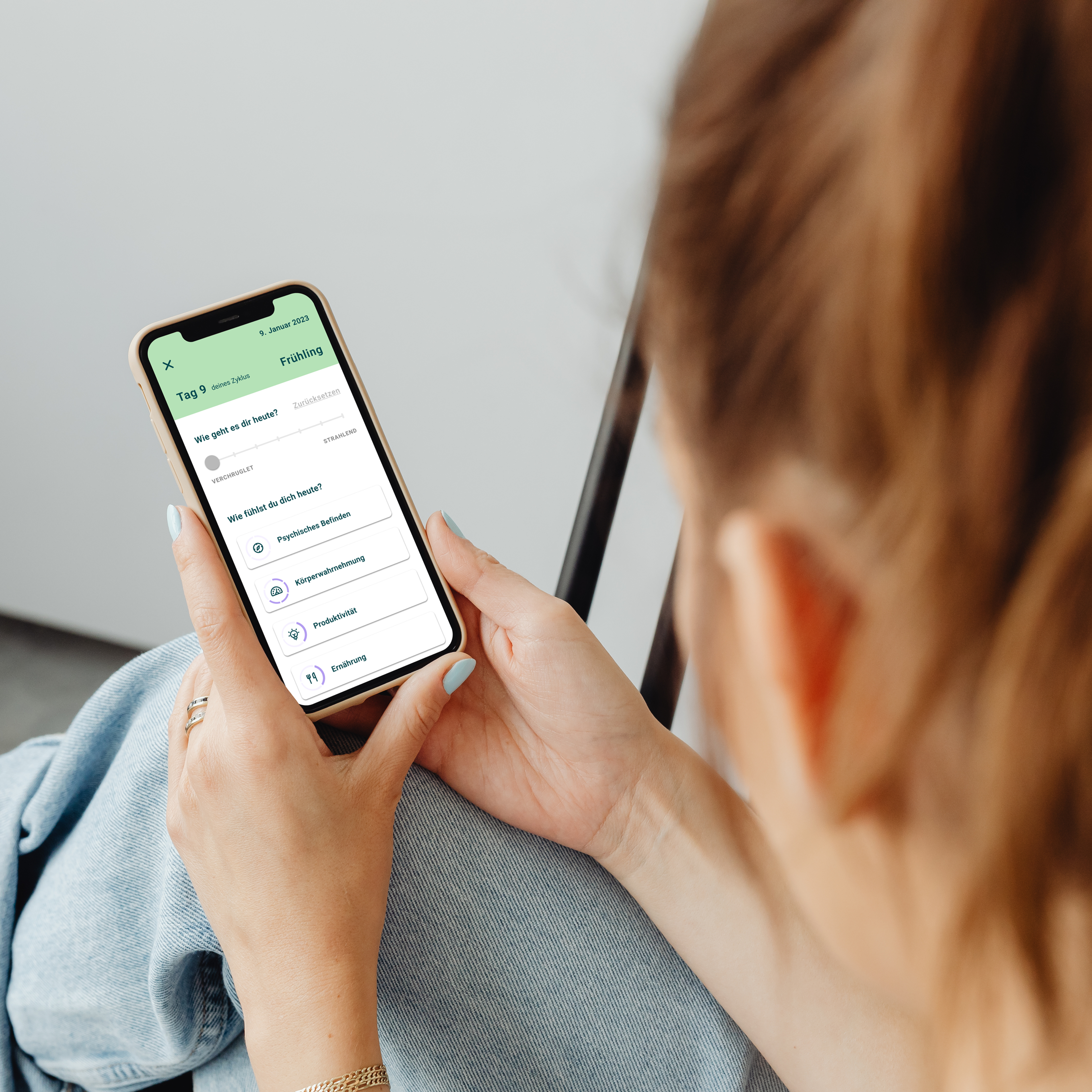 women using the seasons. app on her smartphone