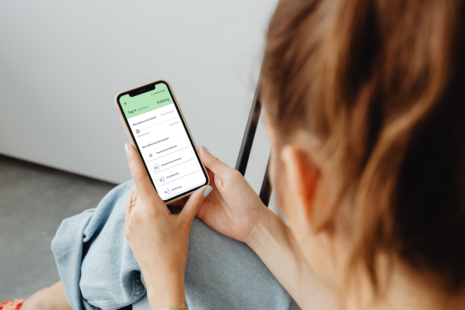 women using the seasons. app on her smartphone