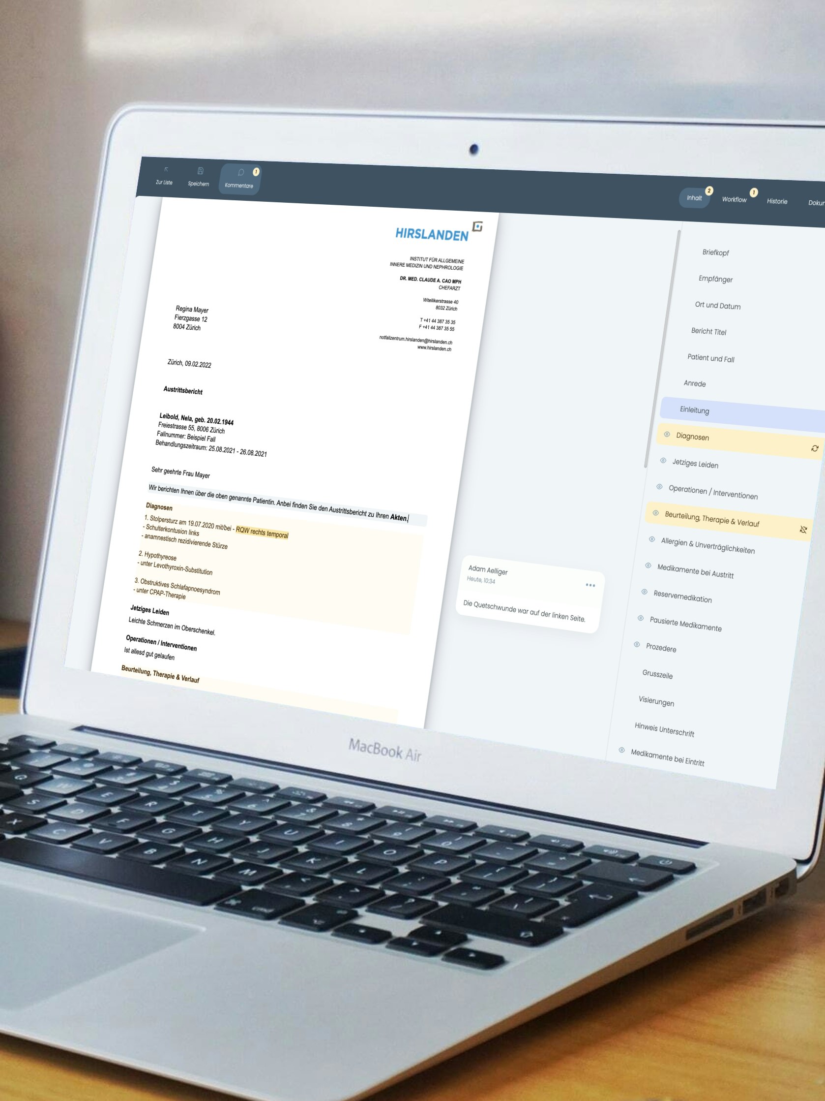 Open laptop on a desk displaying a document and sidebar. A smartphone lies in front of the laptop.