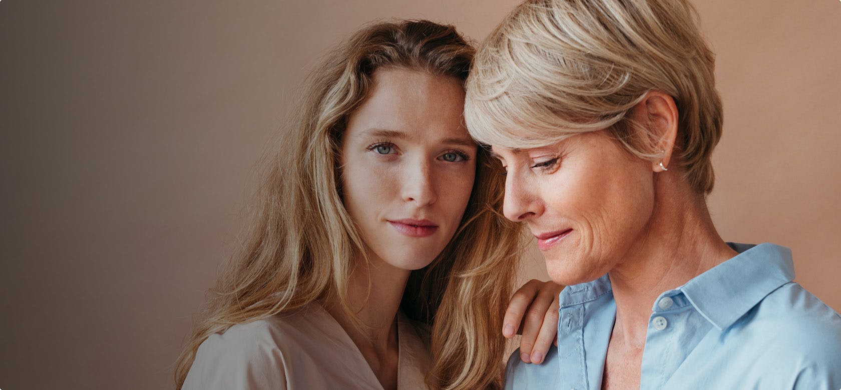 older & younger woman posing together