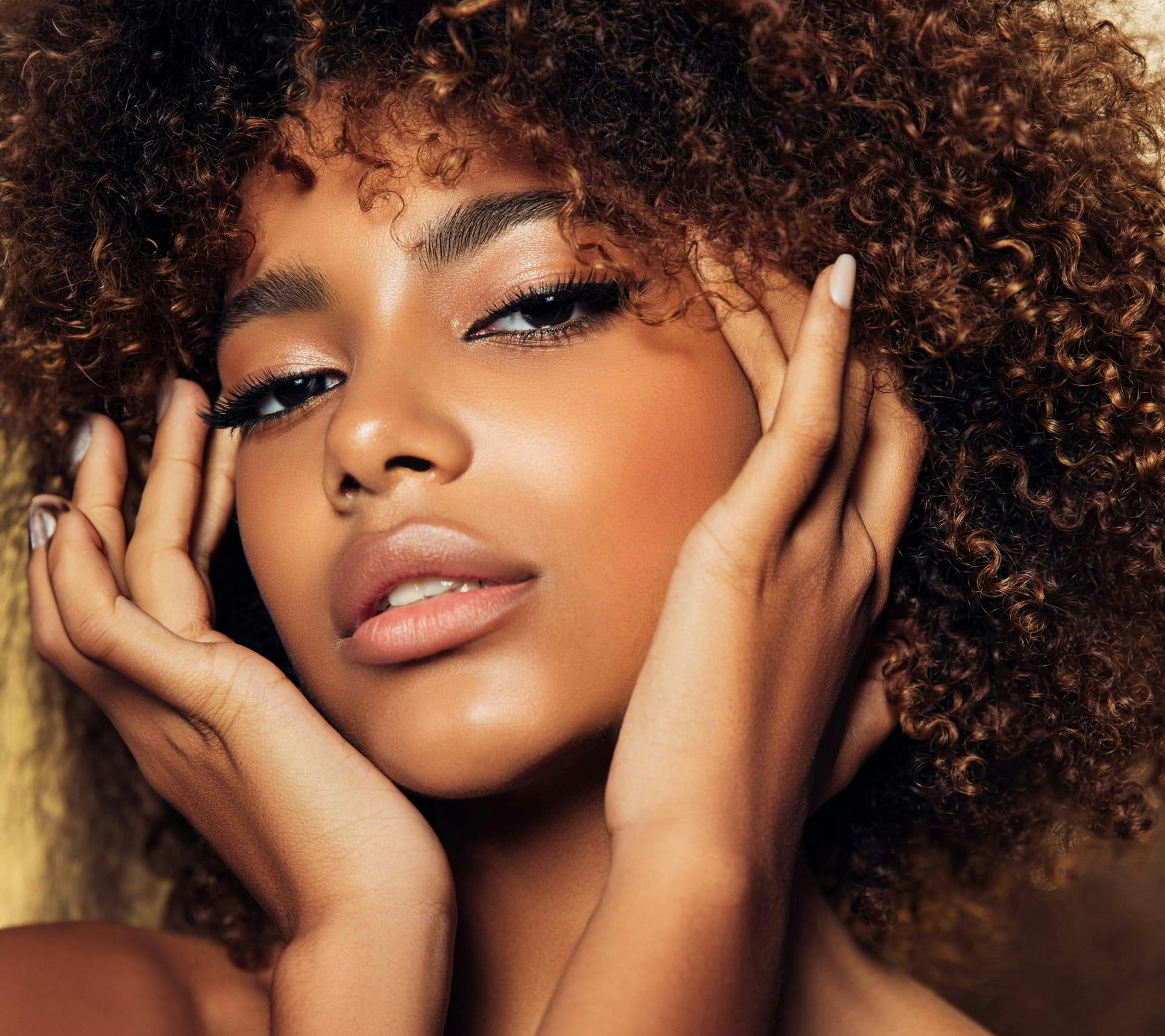 young woman touching face