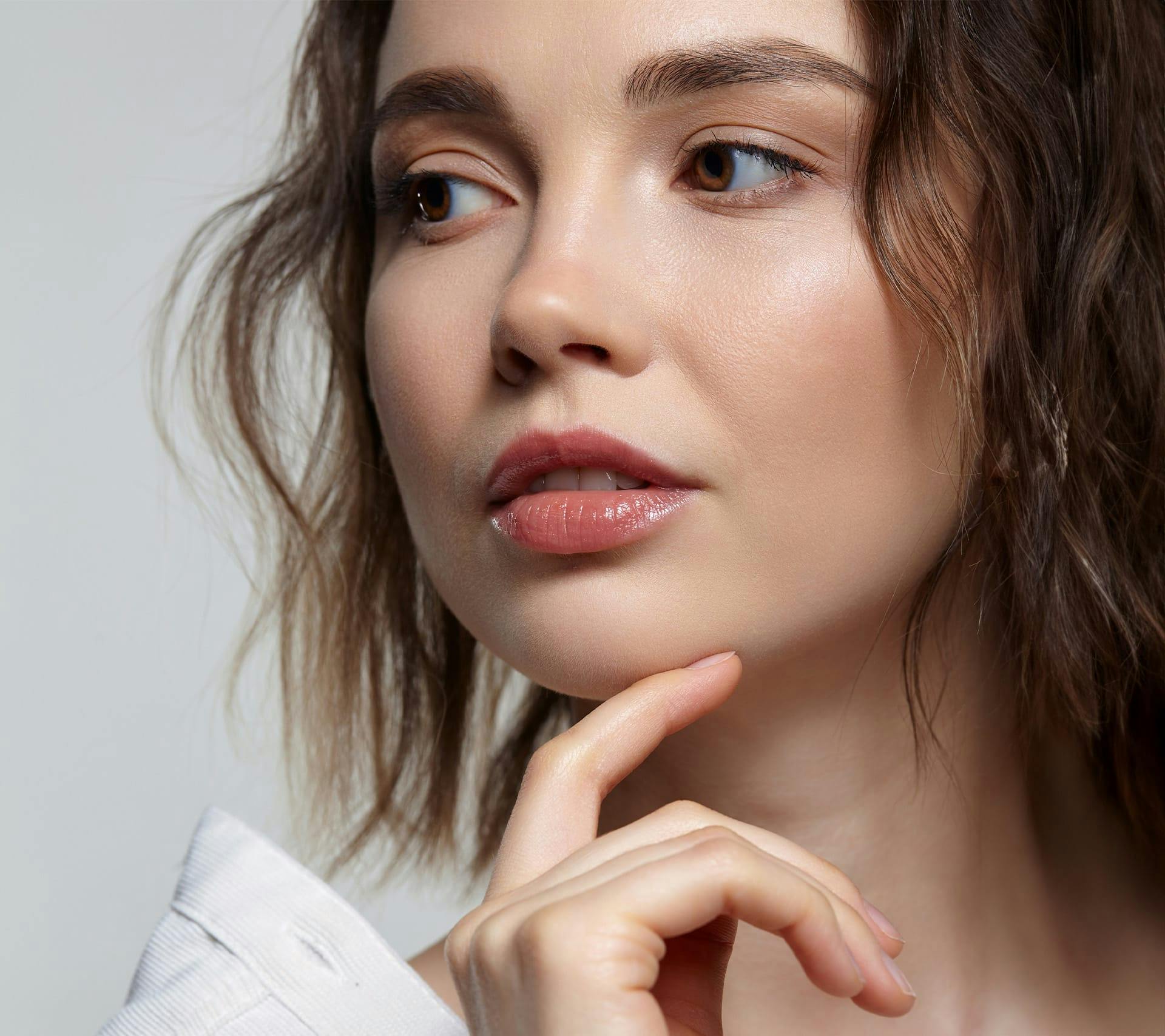 young woman touching face