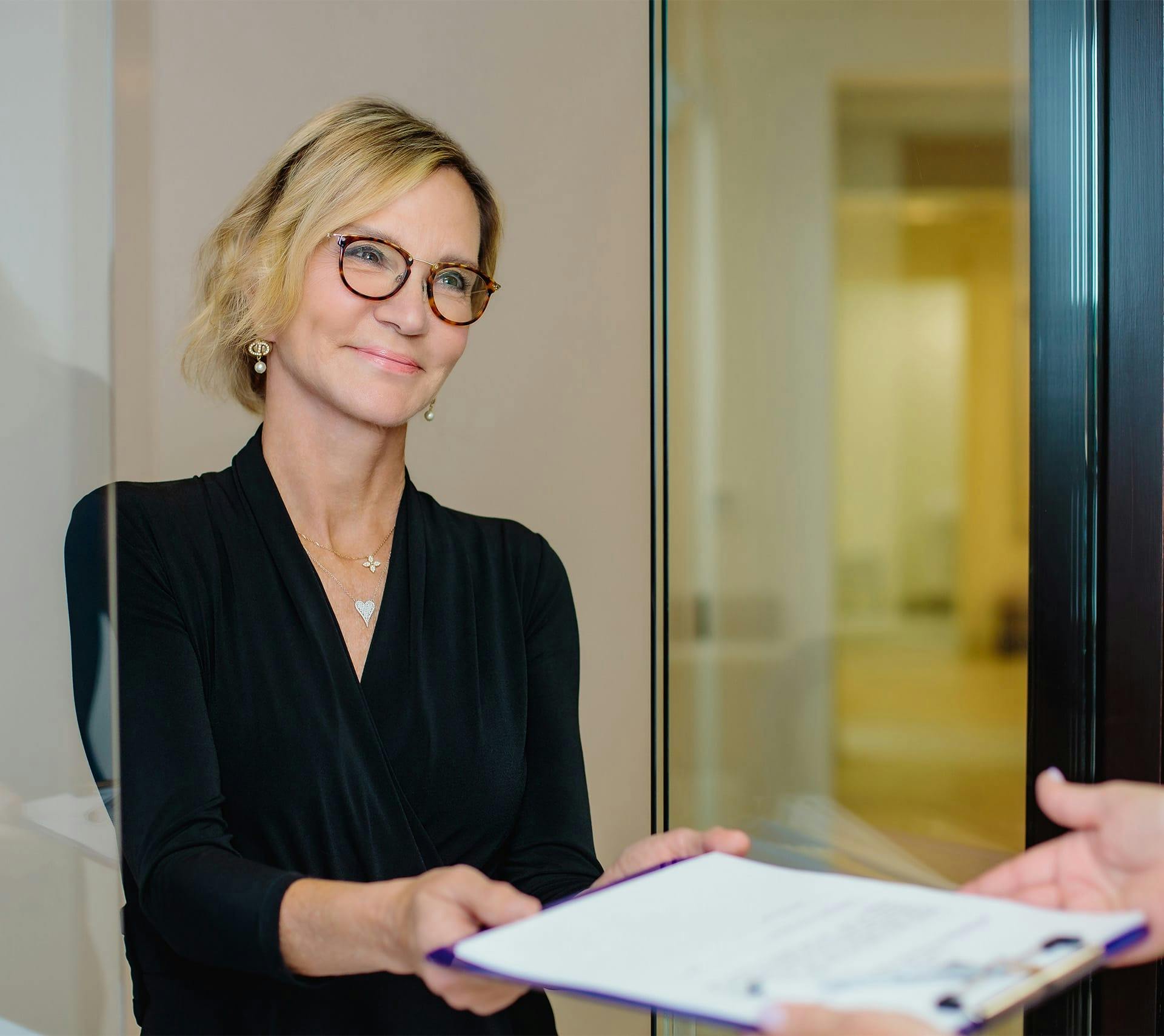 woman smiling with papers