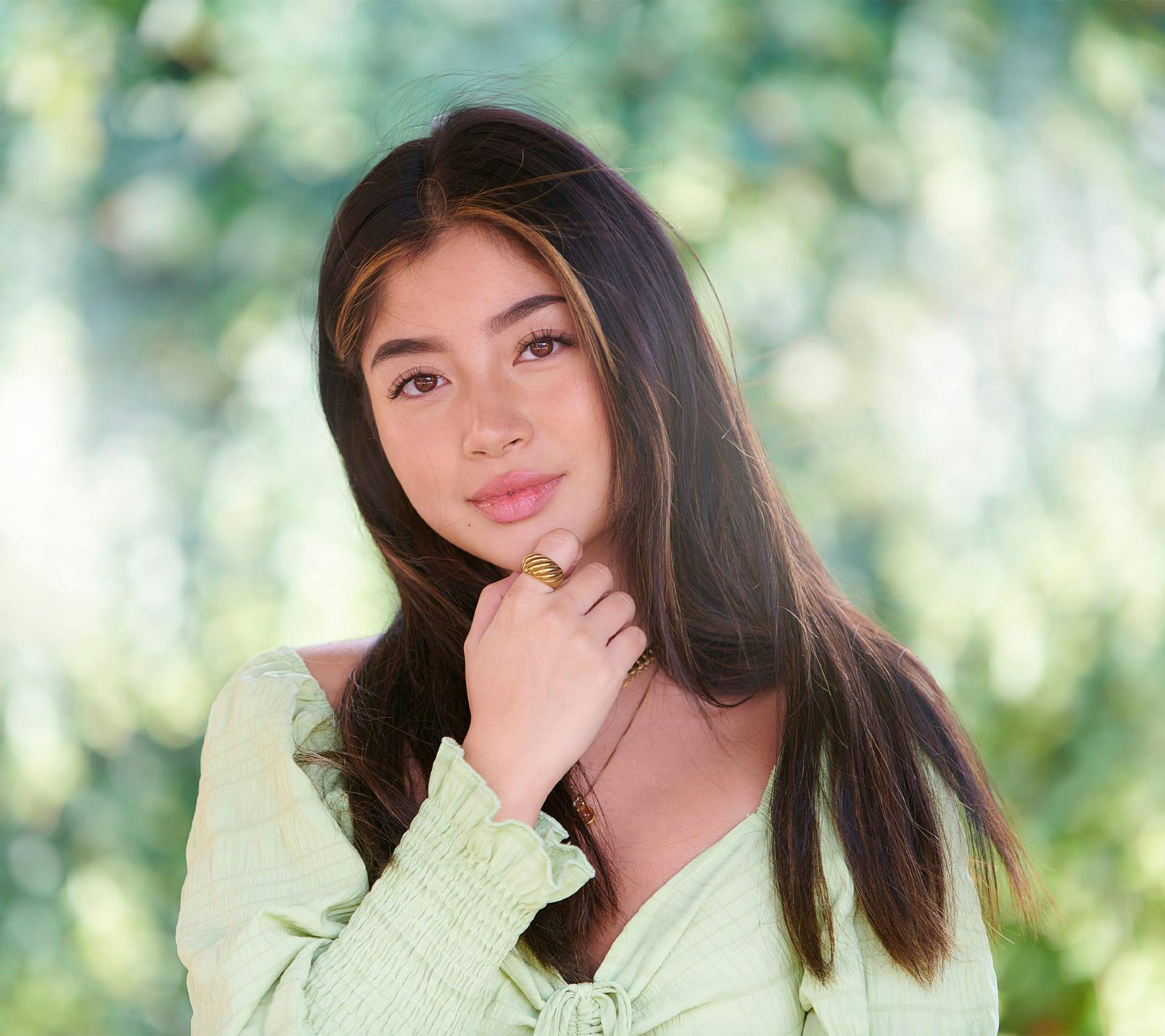 young woman touching face