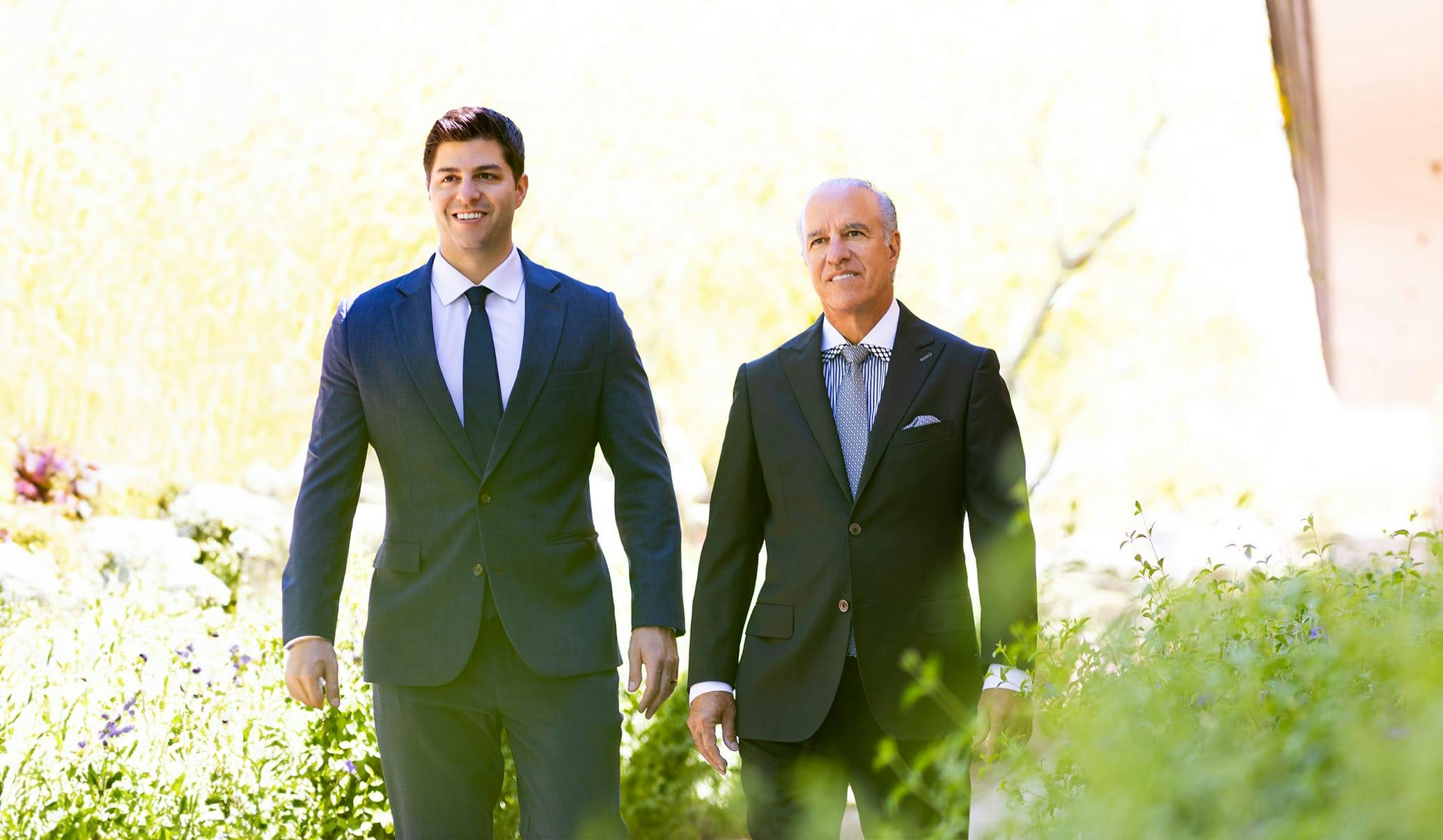 both doctors walking though plants
