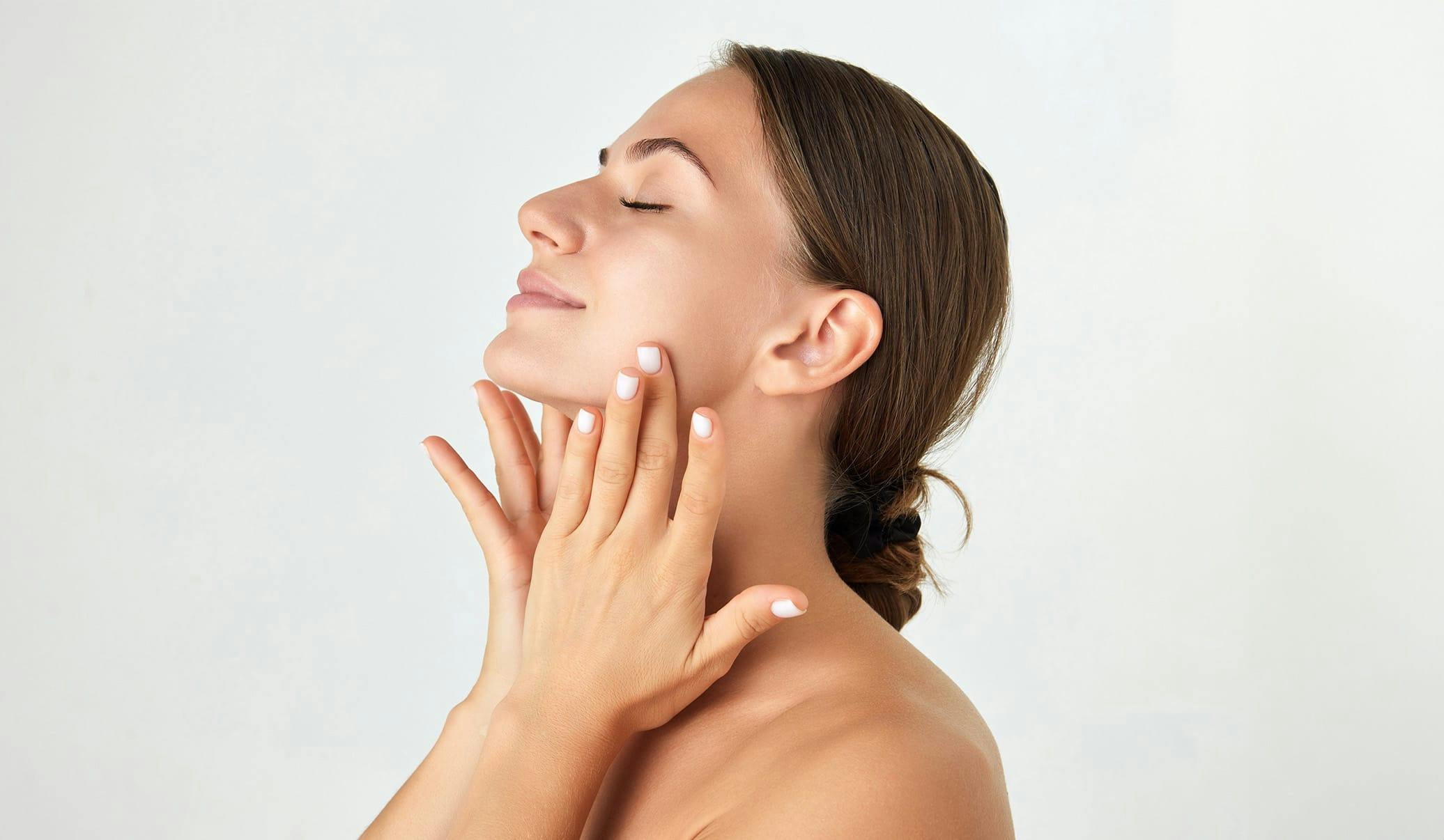 woman touching her neck