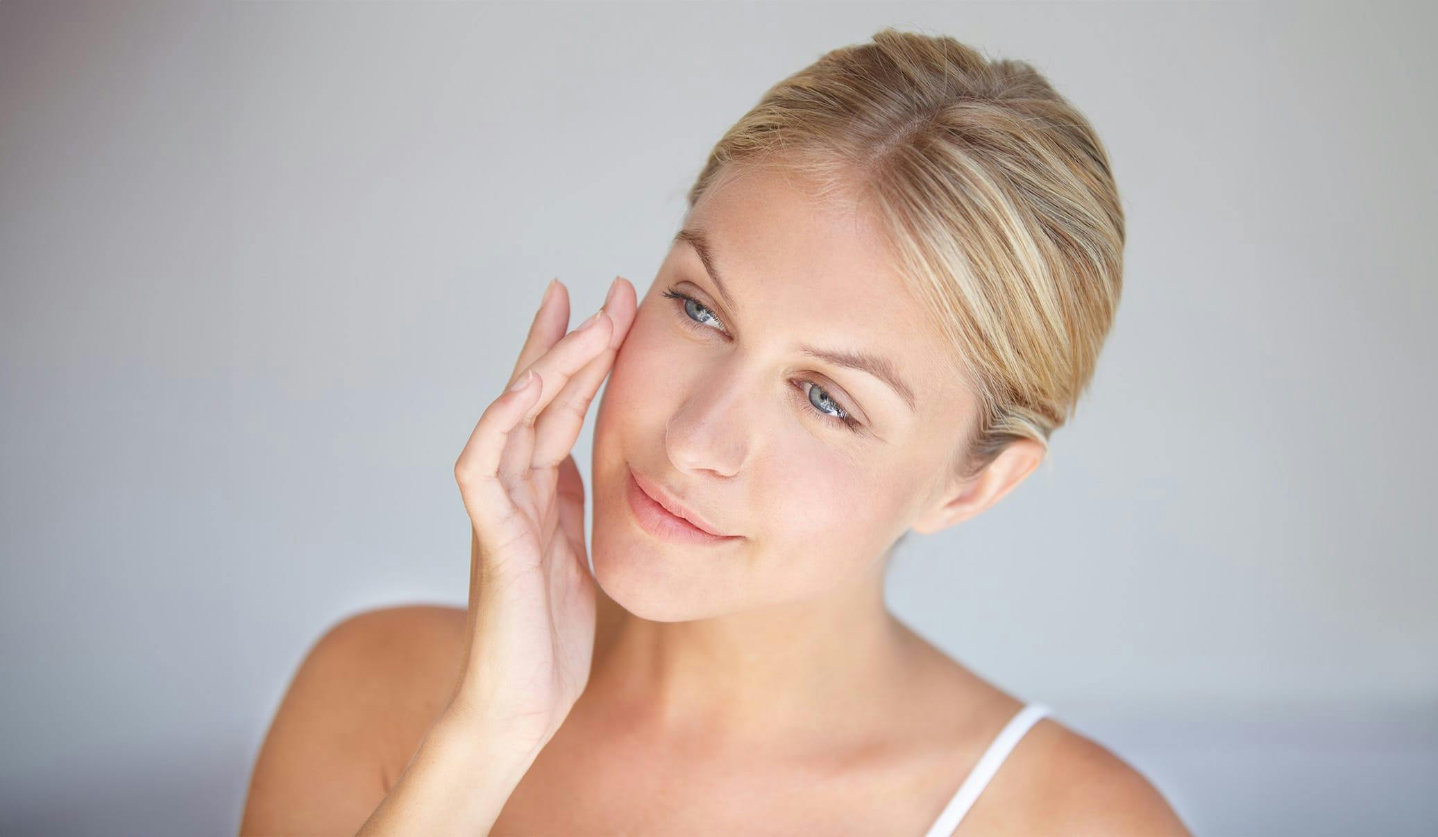 woman touching her face