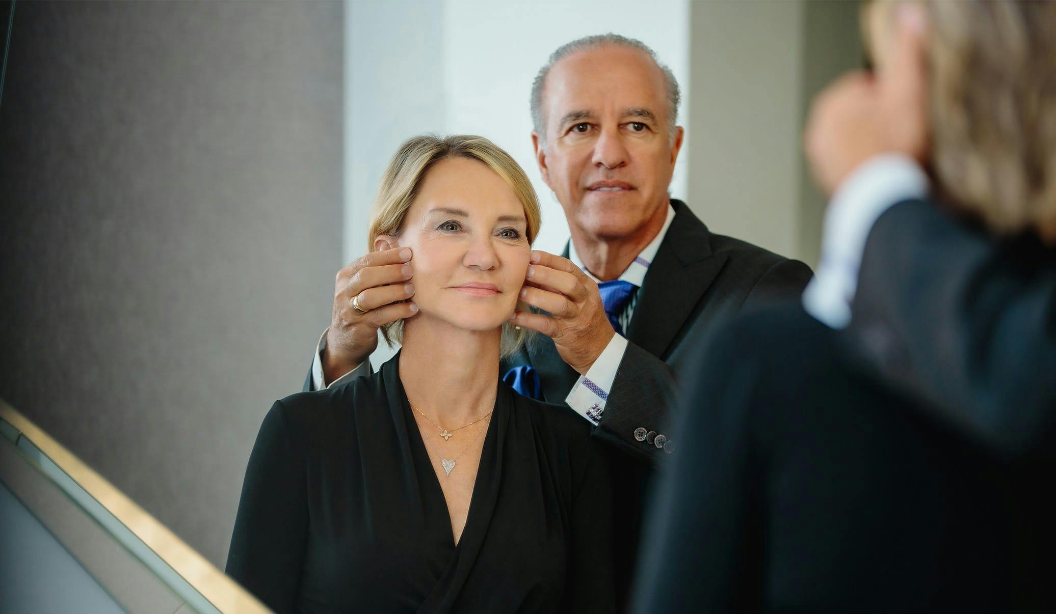 Dr. Caniglia looking in a mirror with a female patient