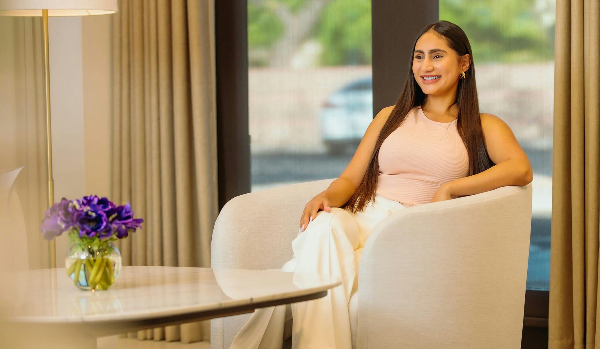 woman sitting in a chair, smiling