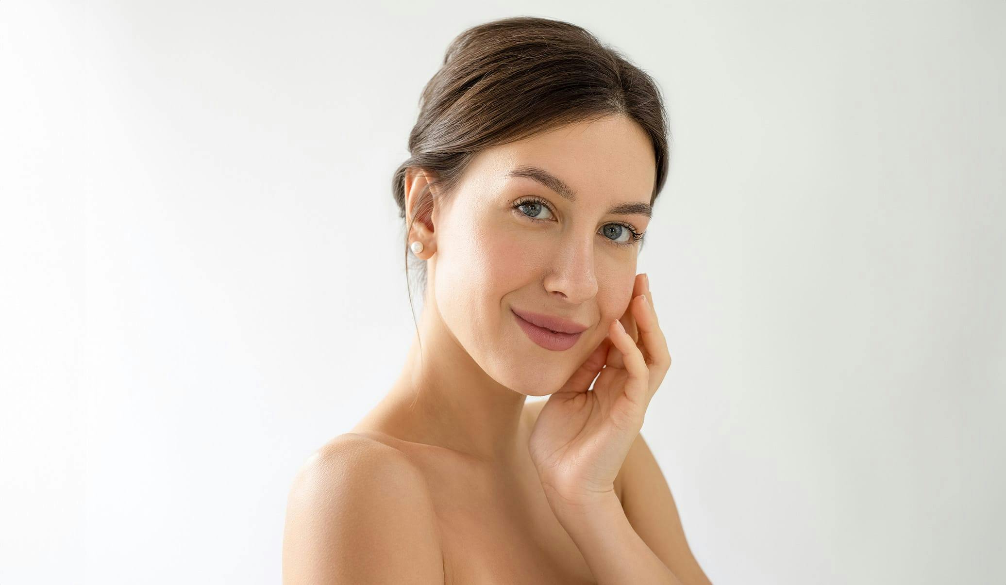 woman touching her face