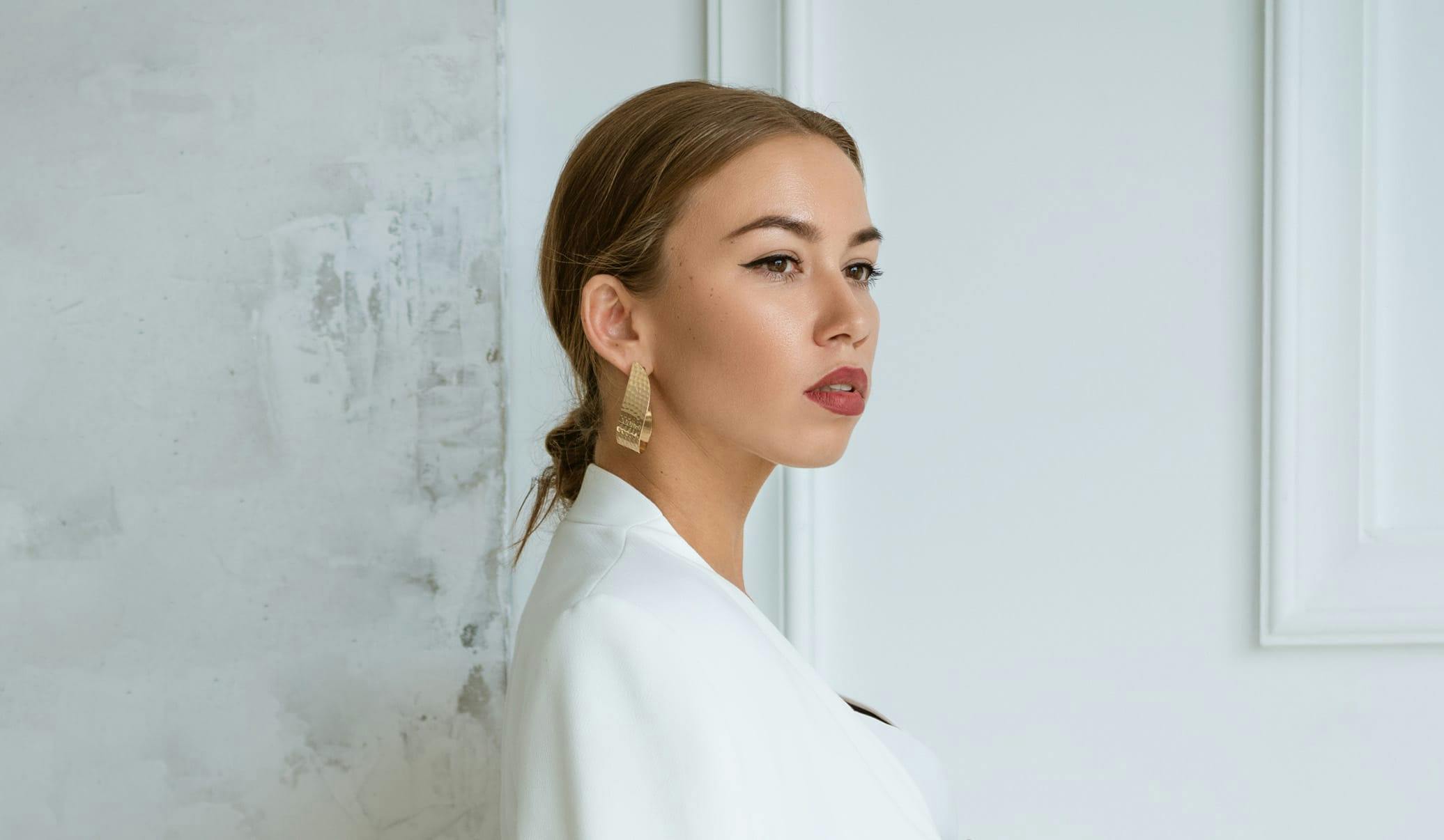 woman wearing glamorous makeup and a white coat