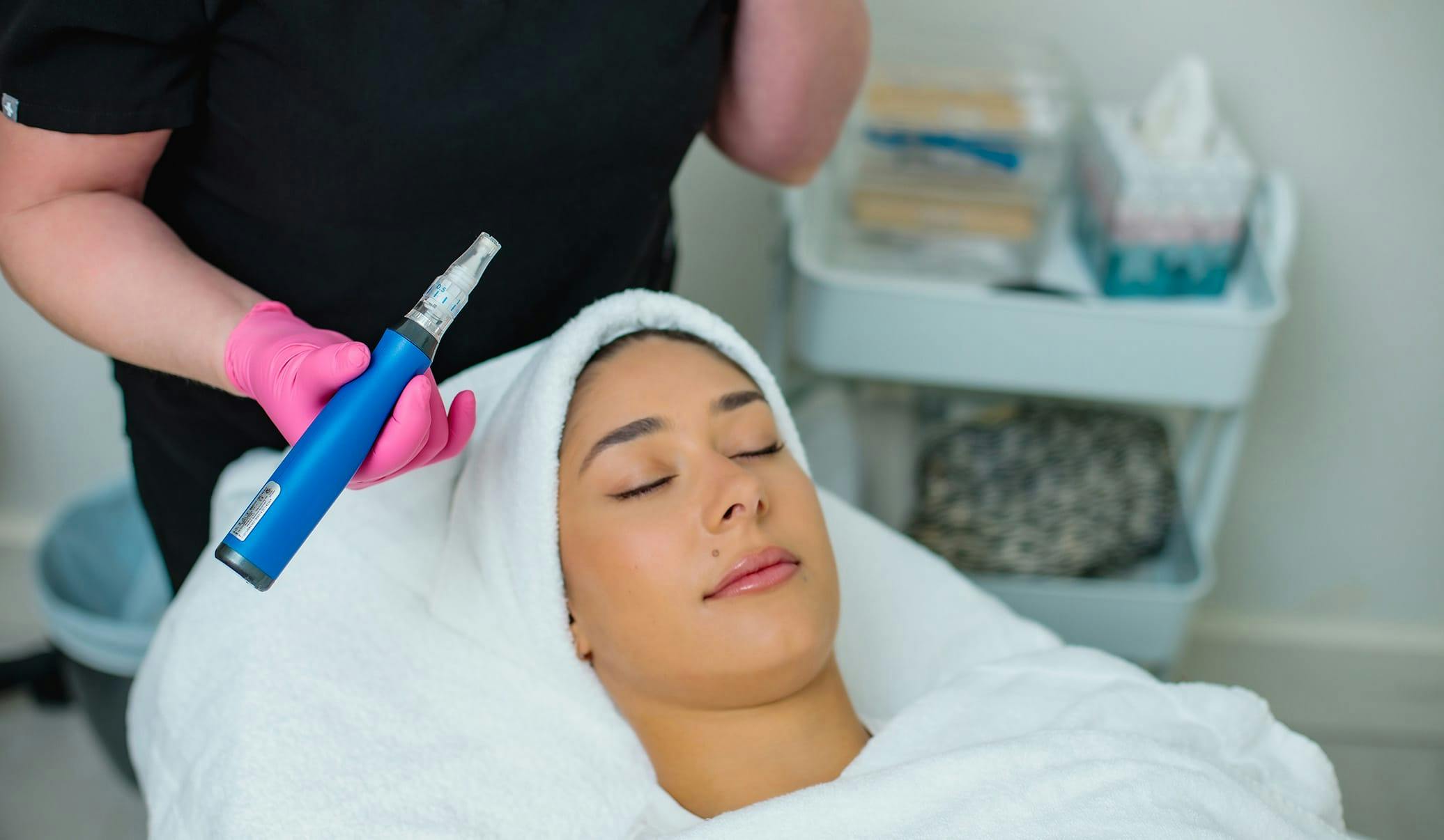 woman receiving microneedling treatment