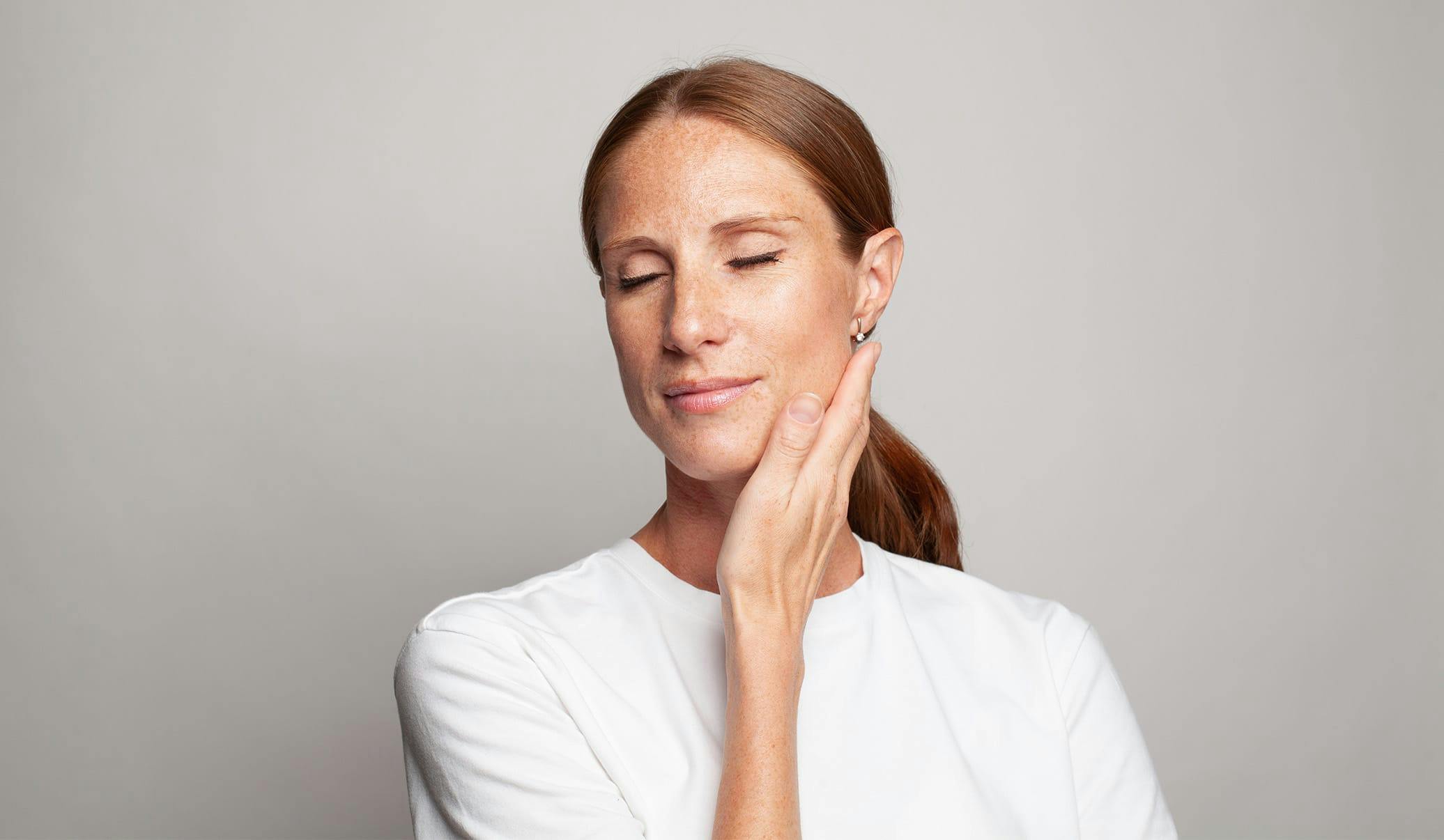 woman touching her neck