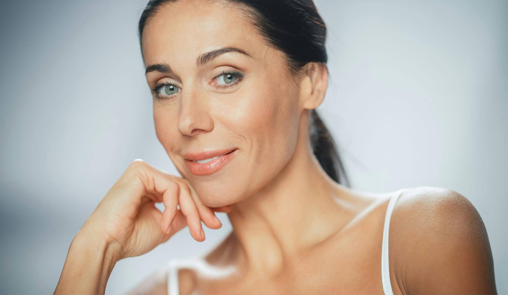woman resting her face on her hand