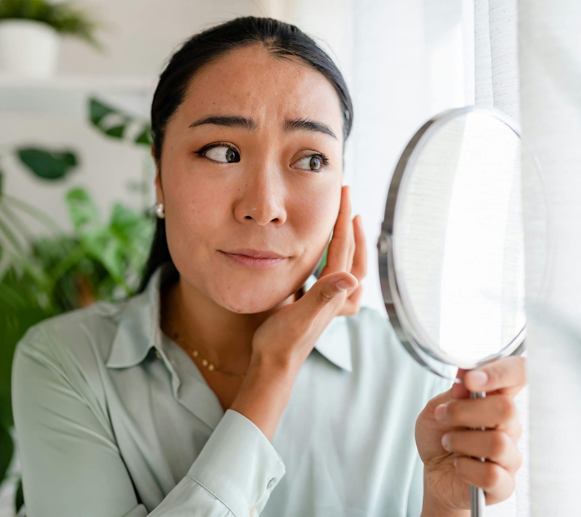 woman looking at herself in a mirror