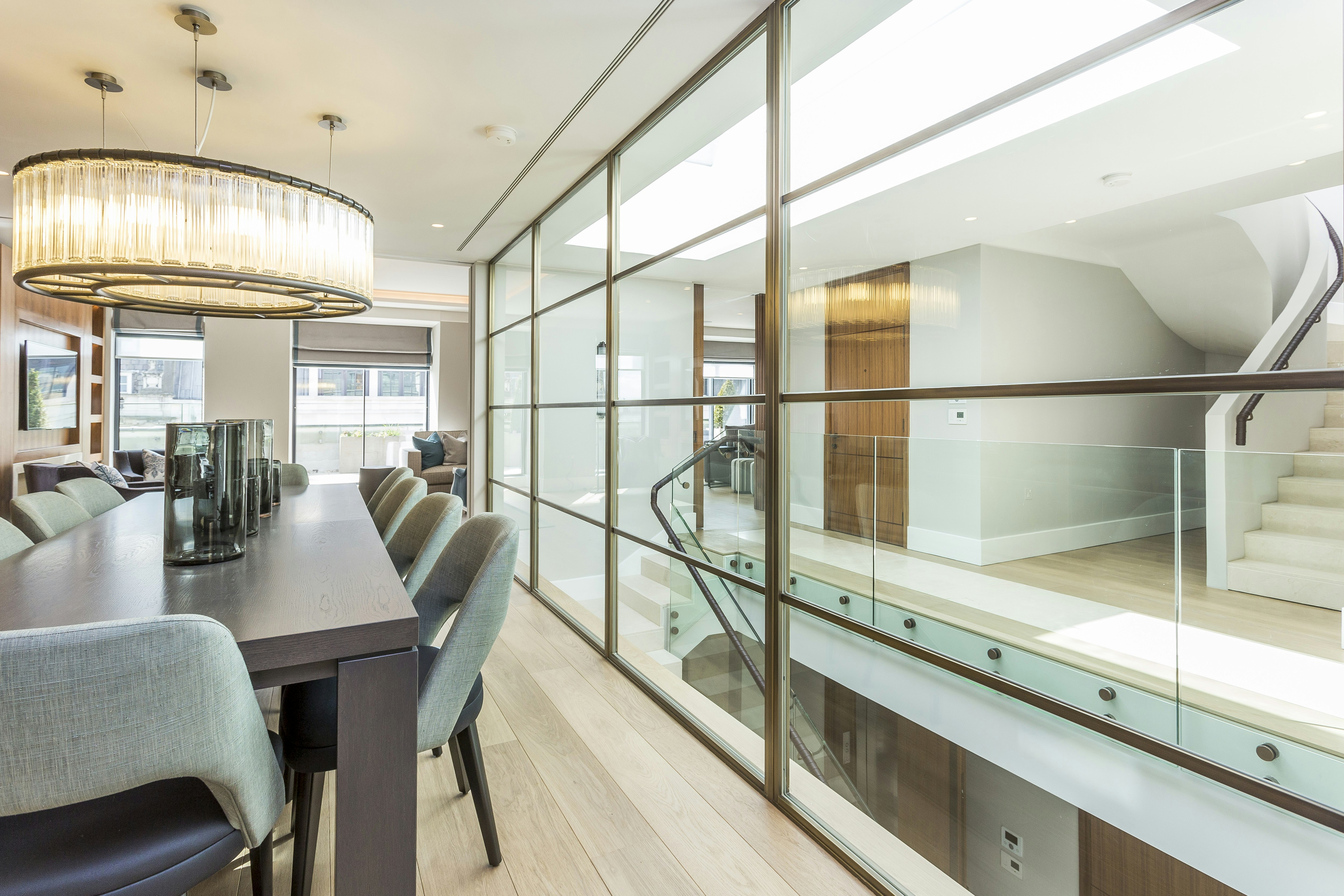 Dining table and chairs and view into building atrium