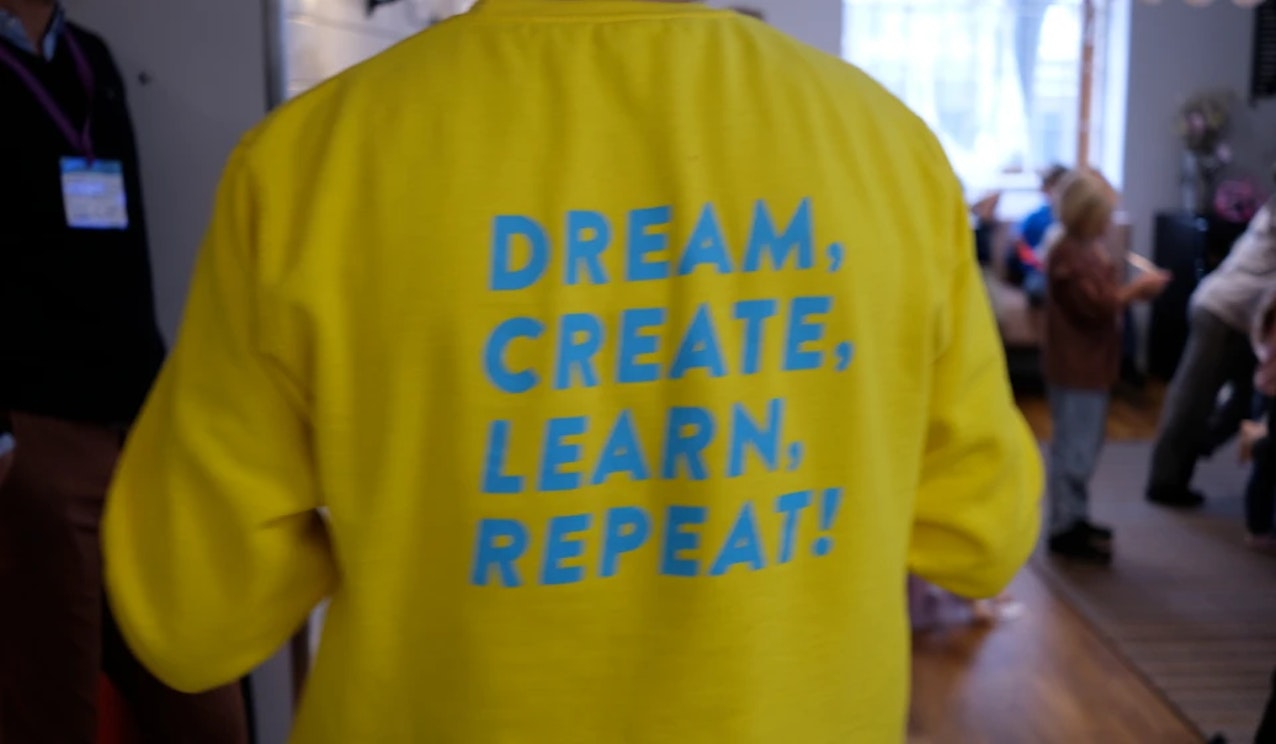 T-shirt with "Dream, Create, Learn, Repeat" statement