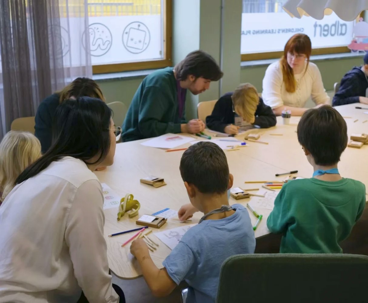 Cheerful children having fun drawing during a class lesson