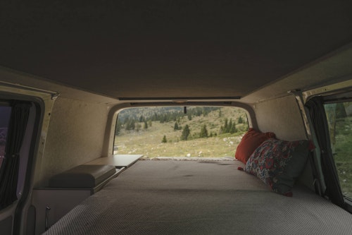 Downstairs bedroom inside a VW T5 from Balkan Campers with a pop top roof in Julian Alps, Slovenia