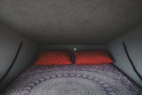 Upstairs bedroom in VW T5 from Balkan Campers with a pop top roof in Julian Alps, Slovenia