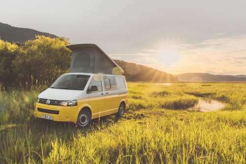 VW T5 Campervan with a pop top roof parked at Cerknica Lake in Slovenia