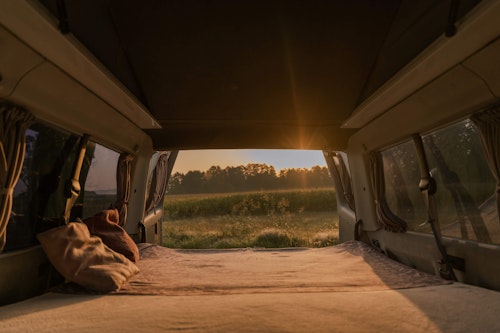 Big cosy double bed in our VW T4 campervan with a  pop top roof.