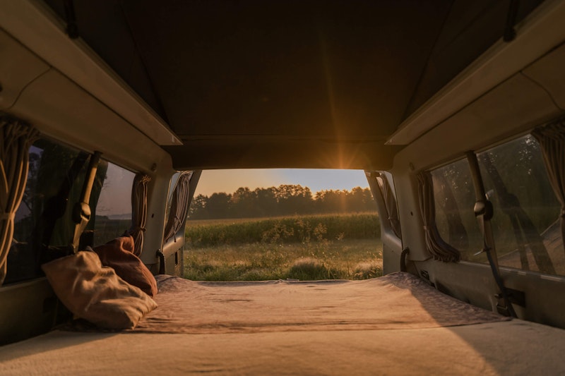Big cosy double bed in our VW T4 campervan with a  pop top roof.