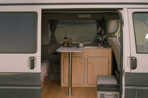 A look through the sliding door to see the inside of our VW T4 campervan with a pop top roof
