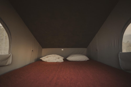 Upstairs bedroom in VW T4 from Balkan Campers with a pop top roof in Ljubljana, Slovenia