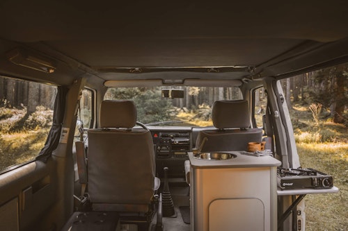 View of the front seats in VW T4 with a pop top roof and 4WD in Slovenian nature