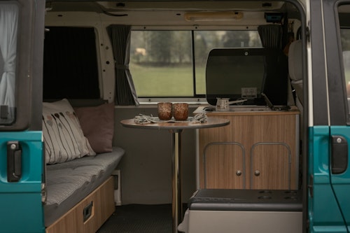 Living space in VW T4 campervan from Balkan Campers with a pop top roof and 4WD