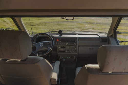 View of the dashboard in VW T4 campervan with a hard roof top and 4 wheel drive in Slovenian mountains