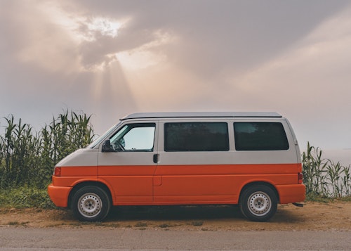 VW T4 campervan with pop top roof from the left side.
