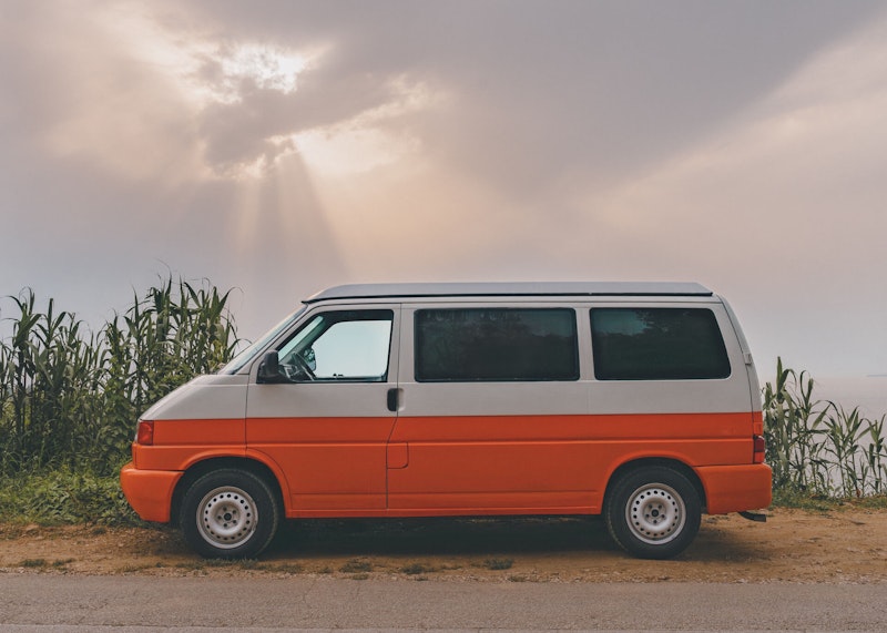 VW T4 campervan with pop top roof from the left side.