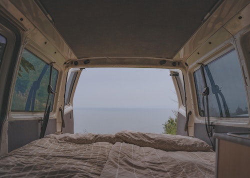 A cosy double bed of our VW T4 campervan with pop top roof Pipi