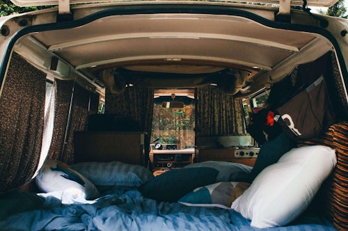 Cosy bedroom of Nissan Datsun original campervan from Balkan Campers
