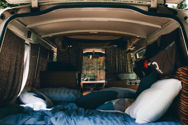 Cosy bedroom of Nissan Datsun original campervan from Balkan Campers