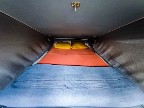 Upper bedroom in VW T4 Campervan Original Westfalia with pop top roof from Balkan Campers in Kobarid, Slovenia
