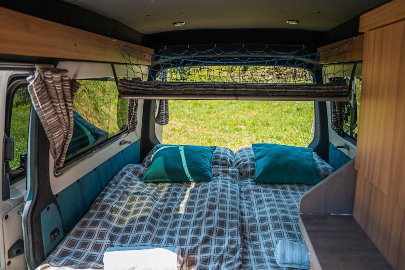Lower bedroom in VW T5 Campervan with hard roof top from Balkan Campers in Ljubljana, Slovenia