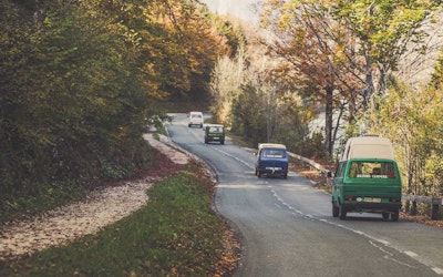 Four VW T3 Campervans from Balkan Campers on regional road at Bohinj Lake in Triglav National Park, Slovenia