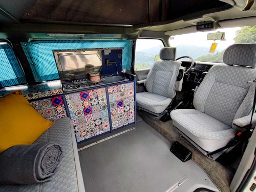 Living space in VW T4 Campervan Original Westfalia with pop top roof from Balkan Campers in Kobarid, Slovenia