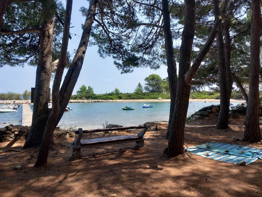 Balkan Campers customers in their VW T5 camper van on the beach in Nerezine, Mali Lošinj